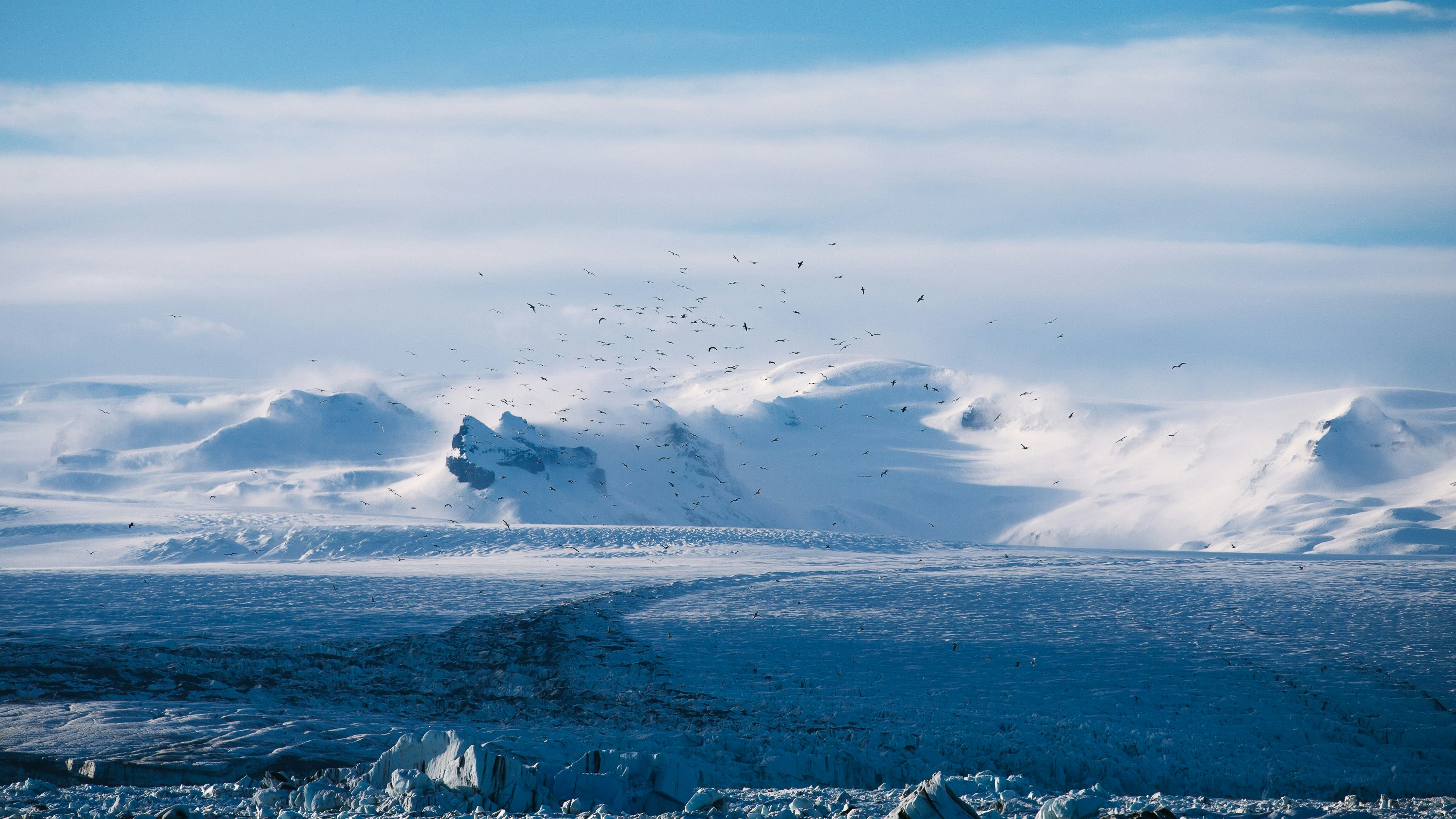 clear blue beside mountain covered with snow